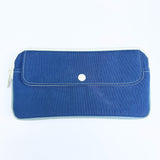 Blue pouch with a white button on a white background