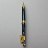 Fountain pen with gold accents on a light beige background