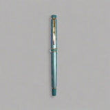 Green pen with gold accents on a light blue background