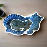 Sticker of a blue and black cat on a wooden surface