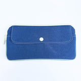 Blue pouch with a white button on a white background